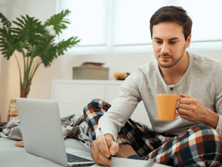 man journaling and drinking coffee during morning routine