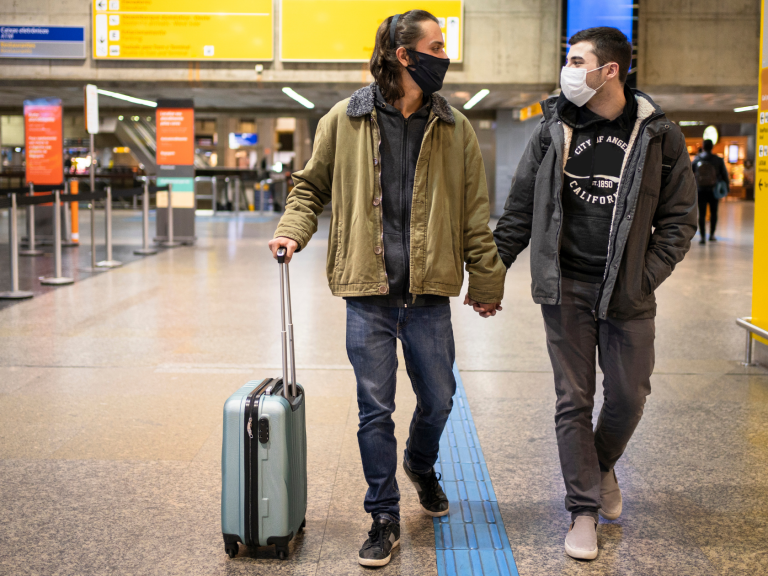 Gay Couple walking In Airport